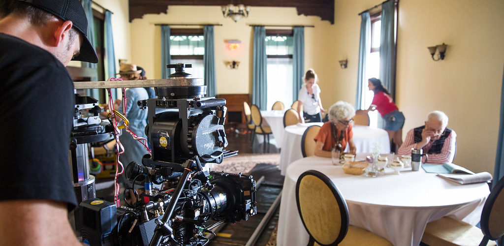 A cameraperson captures a dining room scene during the production of Torching the Dusties